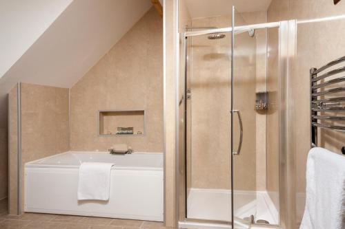 a bathroom with a shower and a bath tub at 9 Bed in Brecon oc-cvelo in Cray