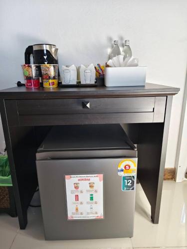 a black table with a trash can under it at Chiang Mai Waroros Boutique Hotel in Chiang Mai