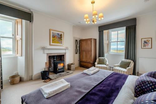 a bedroom with a large bed and a fireplace at 4 Bed in Alyth oc-e31853 in Bridgend of Lintrathen
