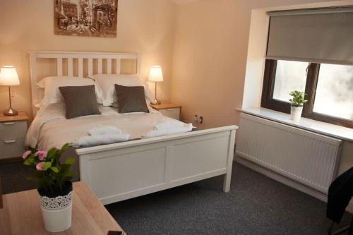 a bedroom with a white bed and a window at 103 Whalley Road Ramsbottom in Ramsbottom