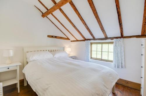 a bedroom with a white bed and a window at 3 Bed in Crayke oc-y056 in Crayke