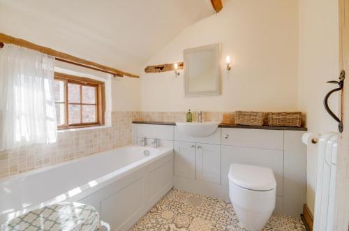 a bathroom with a tub and a toilet and a sink at 3 Bed in Crayke oc-y056 in Crayke