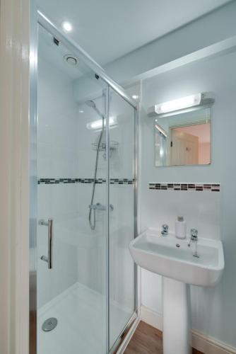 a white bathroom with a sink and a shower at 5 Bed in Muker oc-ds1056 in Muker