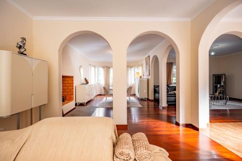 a bedroom with a bed and a living room at The Orange House, By OP in Boaventura