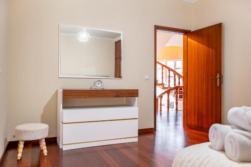 a bathroom with a dresser and a mirror at The Orange House, By OP in Boaventura