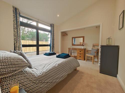 a bedroom with a bed and a window and a desk at 2 Bed in Stanton oc-p30248 in Ticknall