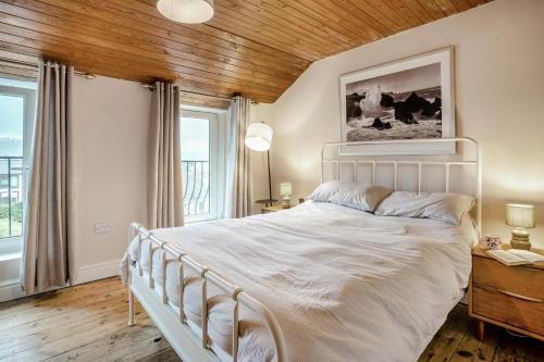 a bedroom with a white bed with a wooden ceiling at 2 Bed in Mumbles oc-v30980 in The Mumbles