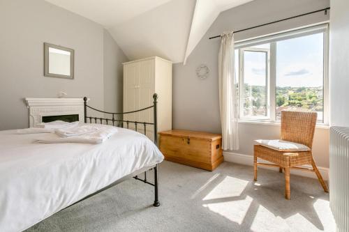 a bedroom with a bed and a window and a chair at 3 Bed in Beer oc-d32358 in Beer