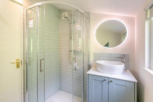 a bathroom with a sink and a glass shower at 3 Bed in Beer oc-d32358 in Beer