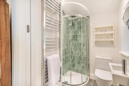a bathroom with a toilet and a glass shower at 5 Bed in Ulpha oc-b32731 in Ulpha