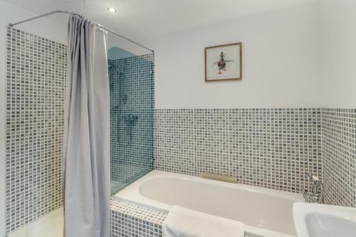 a bathroom with a tub and a sink and a shower at 2 Bed in Hatton oc-t32765 in Peterhead