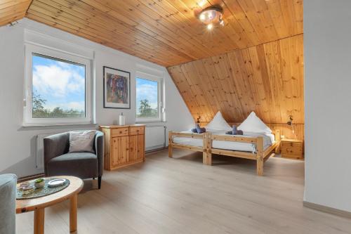 a living room with a bed and a chair at Watt'n Mehr in Krummhörn