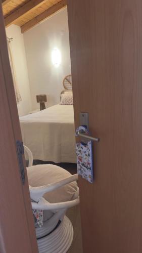 a door open to a room with a bed at Casa do Ti Chico in São Luis