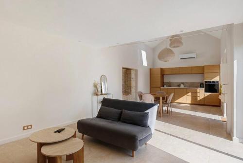 a living room with a couch and a table at La Maison Léoncine in Allonnes