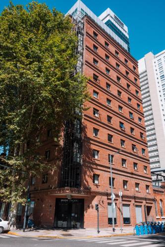 a large red brick building on a city street at Believe Madero Hotel in Buenos Aires