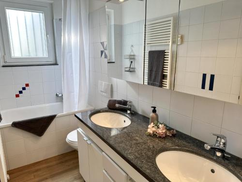 a bathroom with a sink and a mirror at Casa Rondinella by fewotessin in Orselina