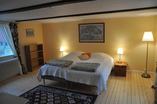 a bedroom with a bed with two pillows on it at The Gardener House - Grönsöö Palace Garden in Grönsöö