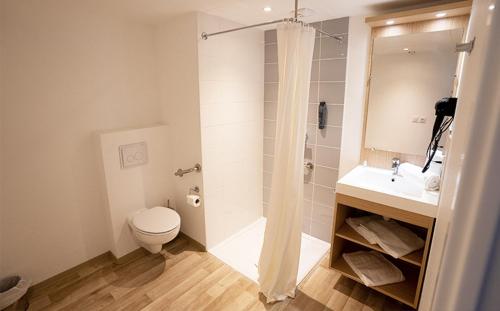 a bathroom with a shower and a toilet and a sink at Résidence Vacances - Azureva sur les Hauteurs de Roquebrune-Cap-Martin in Roquebrune-Cap-Martin