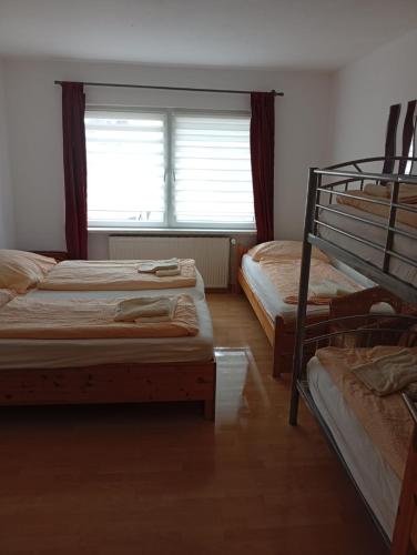 a bedroom with two bunk beds and a window at Ferienhaus Boddensicht in Breege
