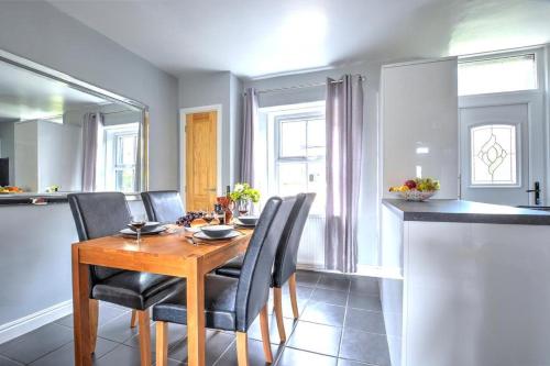a dining room with a wooden table and black chairs at 2 Bed in Skipton oc-ds221 in Skipton