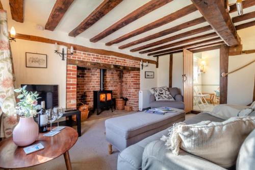a living room with a couch and a fireplace at 2 Bed in Dennington oc-b28093 in Dennington