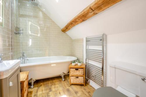 a bathroom with a tub and a sink at 2 Bed in Penmaenpool oc-p32333 in Penmaenpool