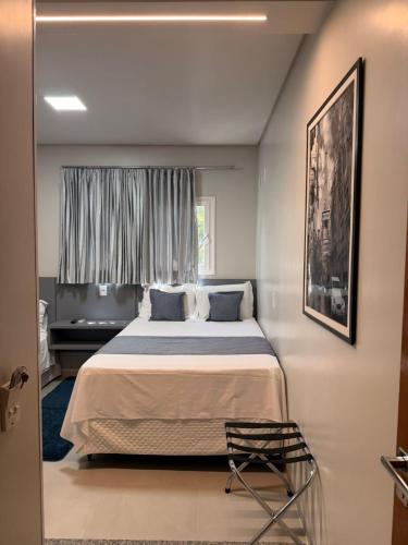 a bedroom with a large bed and a window at PARIS HOTEL in Barreiras