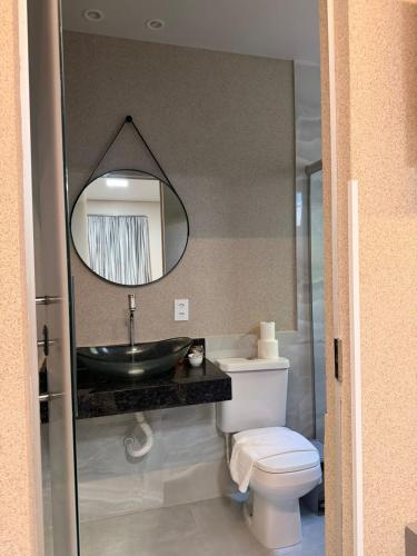 a bathroom with a sink and a toilet and a mirror at PARIS HOTEL in Barreiras