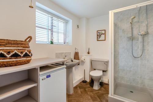 a bathroom with a toilet and a shower and a sink at 4 Bed in Burrowbridge oc-o33020 in Athelney