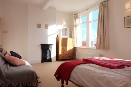 a bedroom with a bed and a window and a dresser at Stunning 3 bed house by Endcliffe Park in Nether Edge