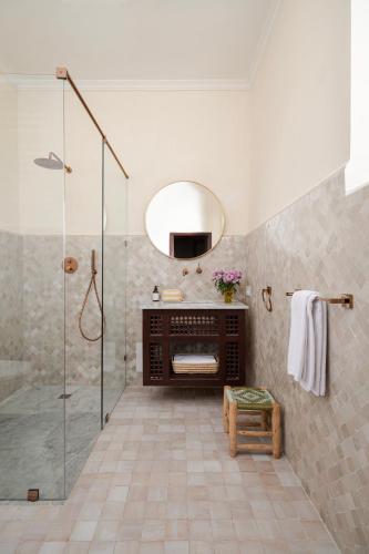 a bathroom with a shower and a mirror at Riad Dar des Arts in Marrakesh