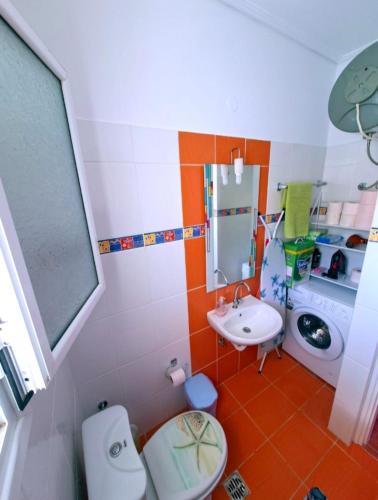 a small bathroom with a toilet and a sink at Home4you in Skala Mistegnon