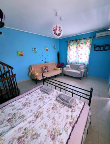 a living room with two beds and a couch at Home4you in Skala Mistegnon