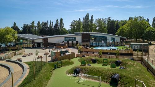 a large building with a playground in front of it at Billing Aquadrome Holiday Park in Great Billing