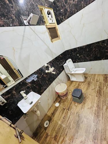 a bathroom with a sink and a toilet at Kirpalu haridham hotel in Vrindāvan