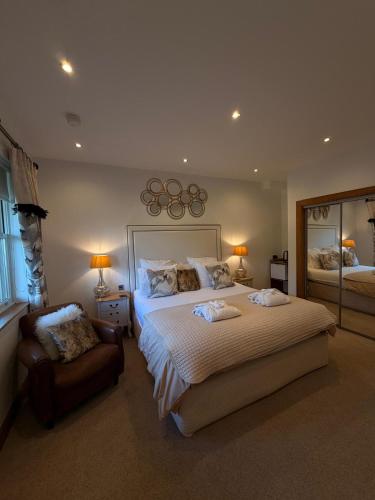 a bedroom with a large bed and a mirror at The Stables Luxury B&B in Bury
