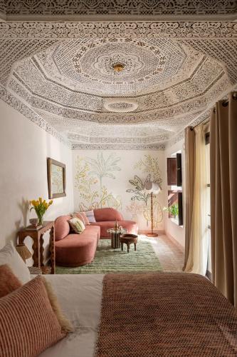 a living room with a coffered ceiling with a couch at Riad Dar des Arts in Marrakesh
