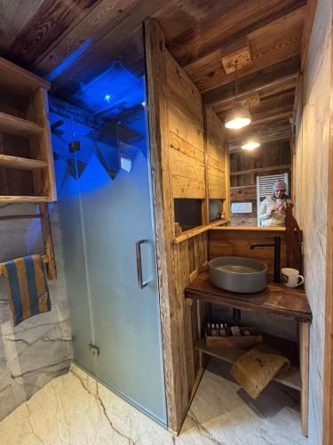 a bathroom with a sink and a blue ceiling at Cuore Tana dell'Orso in Campitello di Fassa