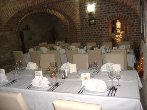 a table with glasses and napkins on top of it at Hotel Varazdin in Varaždin