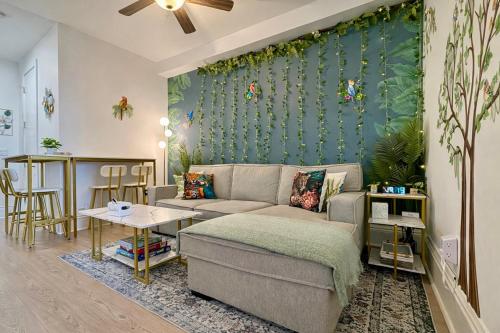 a living room with a couch and a green wall at Garden Street Retreat - 15 Minutes to NYC in Hoboken