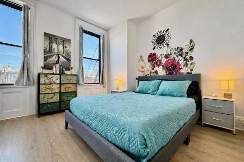 a bedroom with a bed and a large window at Garden Street Retreat - 15 Minutes to NYC in Hoboken