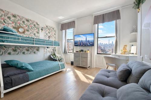a bedroom with a bunk bed and a couch at Garden Street Retreat - 15 Minutes to NYC in Hoboken