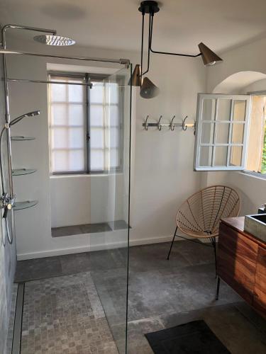 a bathroom with a shower and a glass shower stall at Large period house with panoramic view in Canari