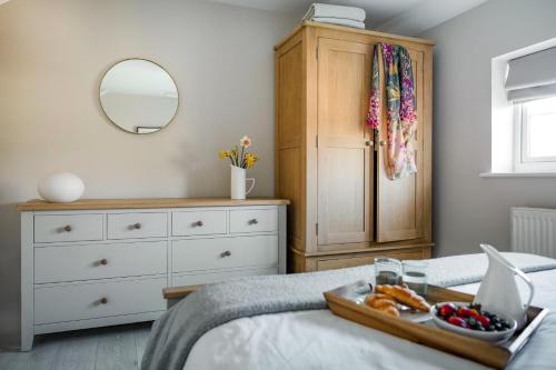 a bedroom with a tray of fruit on a bed at 2 Bed in St Helens oc-76608 in Brading