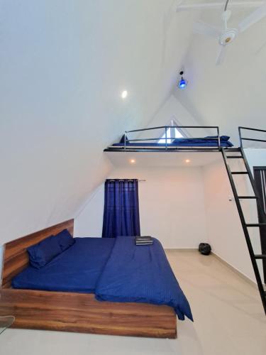a bedroom with a bunk bed and a ladder at Mung Kham Stays in Jorhat