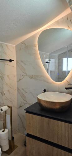 a bathroom with a sink and a mirror at Safari Beach guest house in Lagos