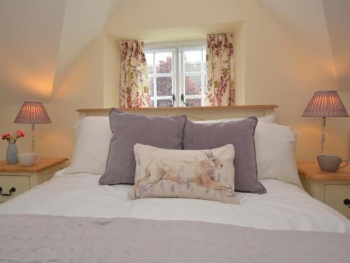 a bed with a pillow on it with two lamps at 1 Bed in Sherborne oc-51018 in Bradford Abbas