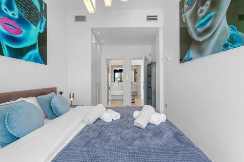 a bedroom with a large bed with towels on it at Villa Sol in Orihuela Costa