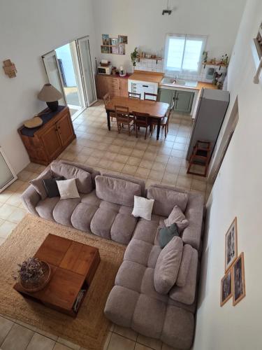 an overhead view of a living room with a couch and a table at kaz Lé pa si Ô in La Rivière
