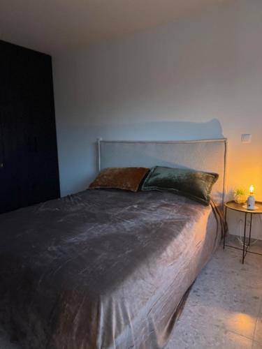a bedroom with a bed with two pillows on it at The Corner-MARGO in Beernem